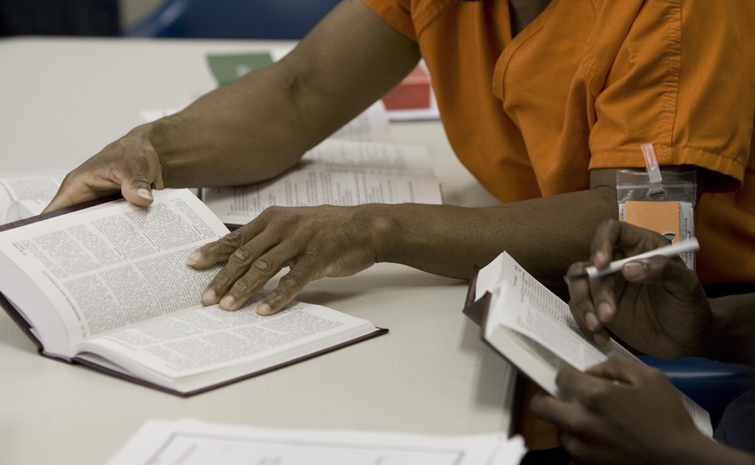 Incarcerated students studying in a prison law library